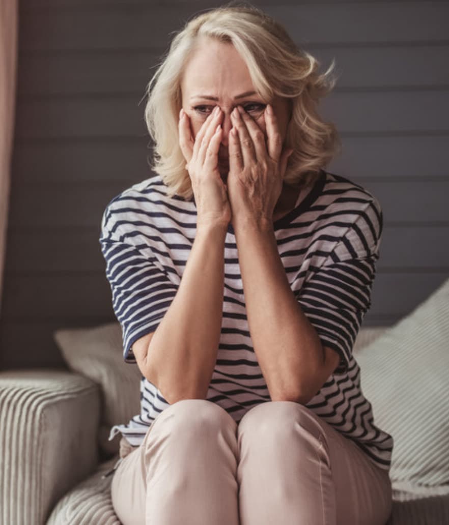 A midlife woman overcome in a hard moment
