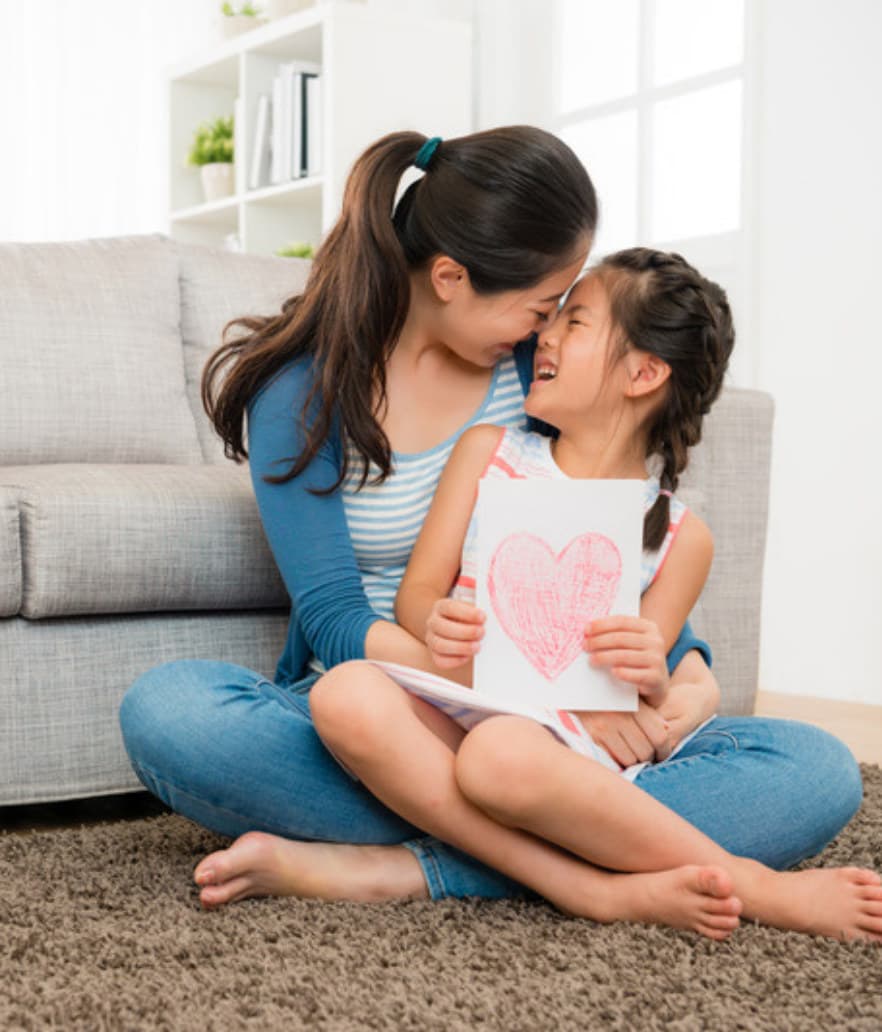 A mom and her daughter sharing her artwork