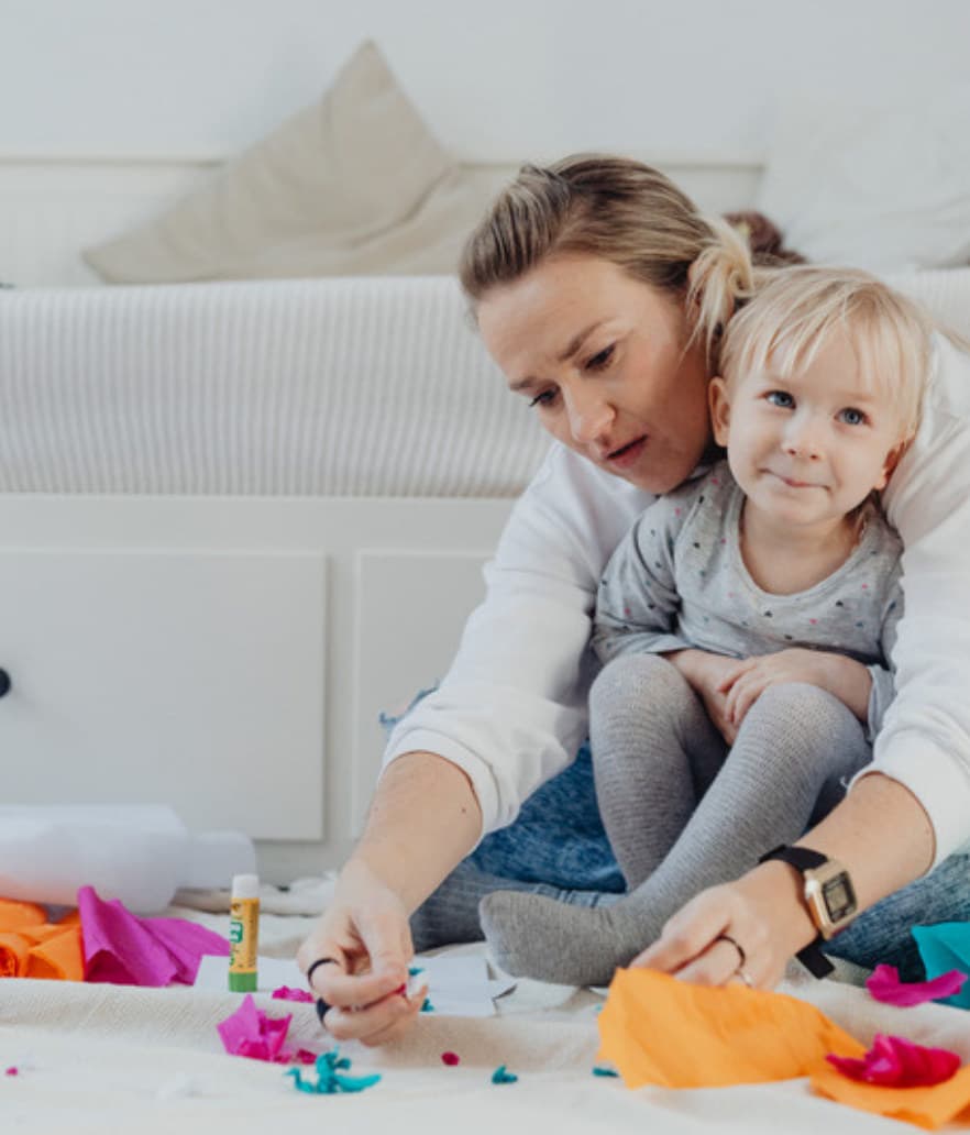 A mom doing crafts with her toddler