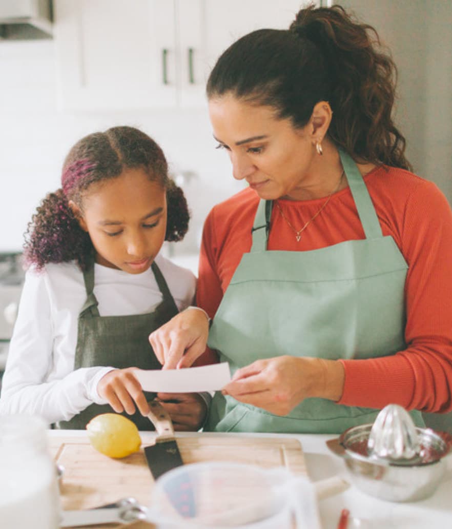 A mom baking with her tween daughter