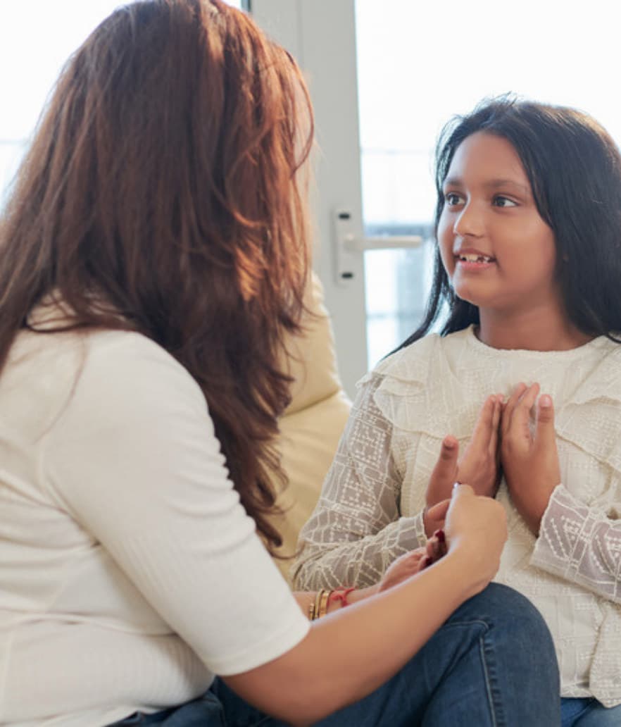 A mom in conversation with her school-age daughter