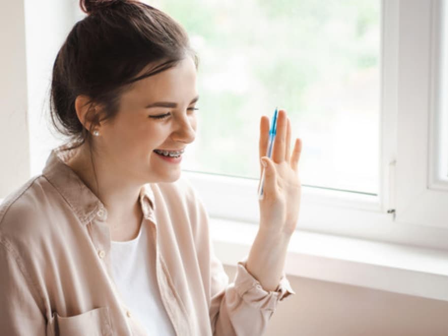 A mom waving to her therapist at the start of a video session
