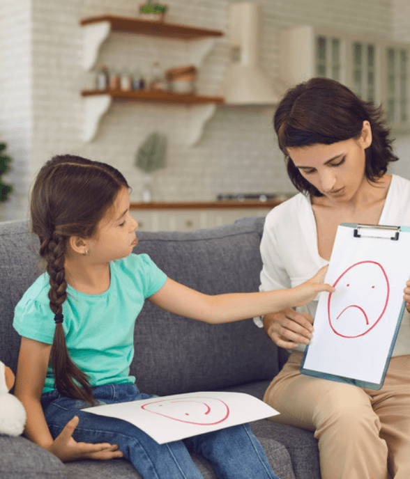 A mom and her older child sitting together, talking