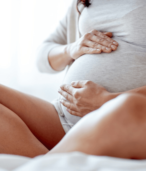 A pregnant mom sitting quietly with a heavy feeling