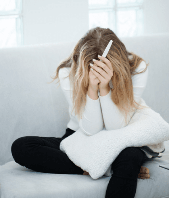 A mom sitting on the floor, flooded by big emotions in a hard moment