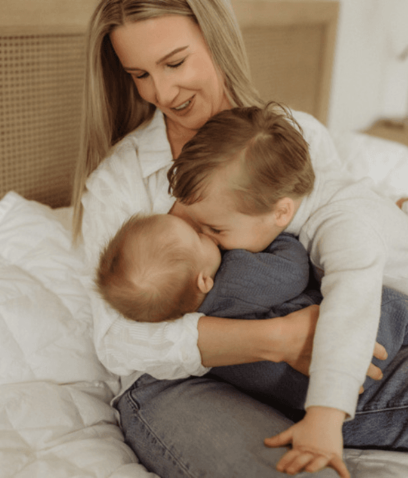 A mom cradling her baby with love