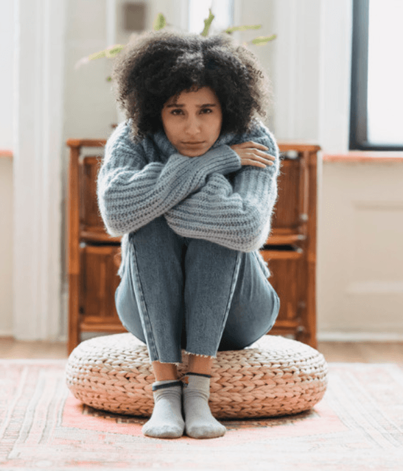 A mom sitting alone, withdrawn and weary