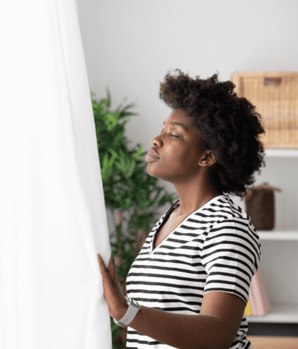 A mom pausing by the window, overwhelmed