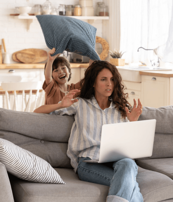 A mom tidying her home while her child plays nearby