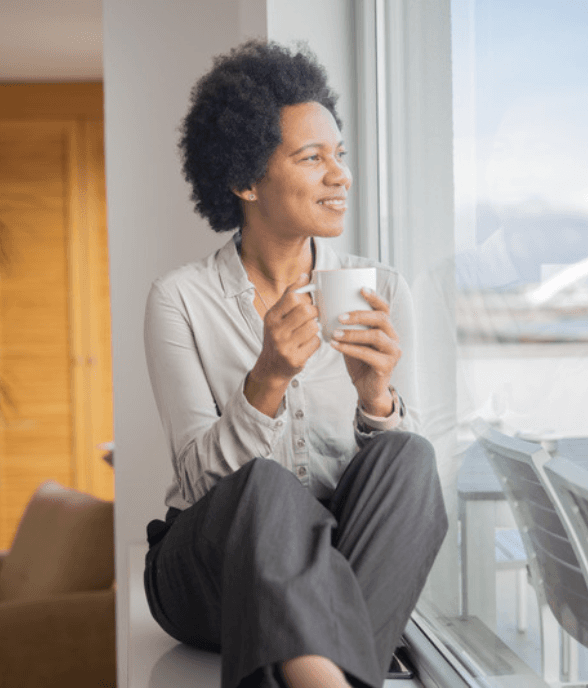 A woman in her forties sitting reflectively