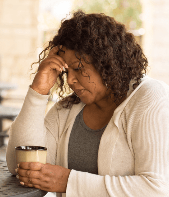 A woman with a warm drink in a calmer moment