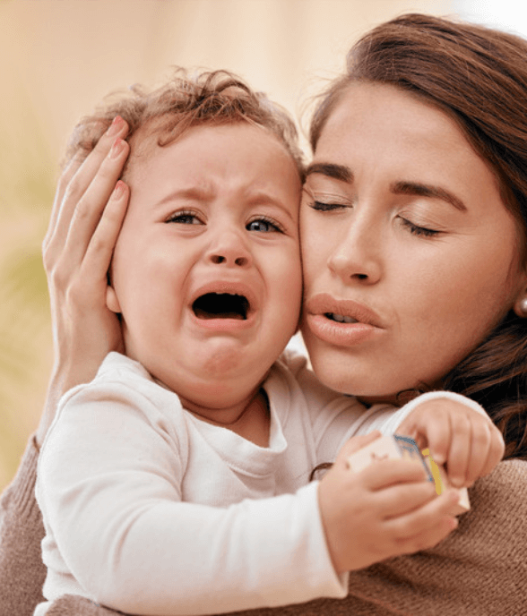 A mom comforting her crying toddler