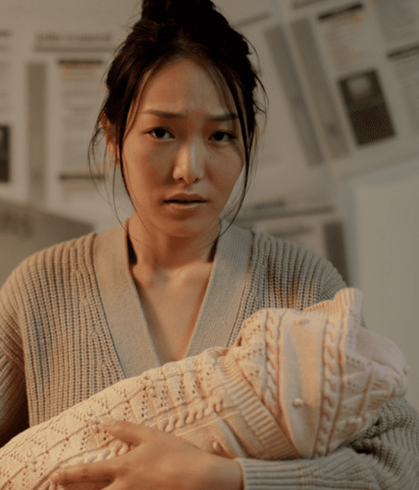 A mom holding her child close
