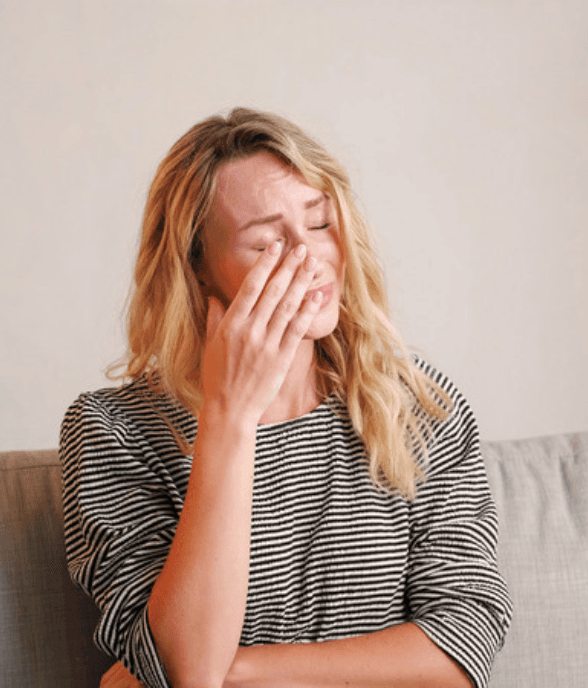 A stepmom looking overwhelmed and discouraged at home