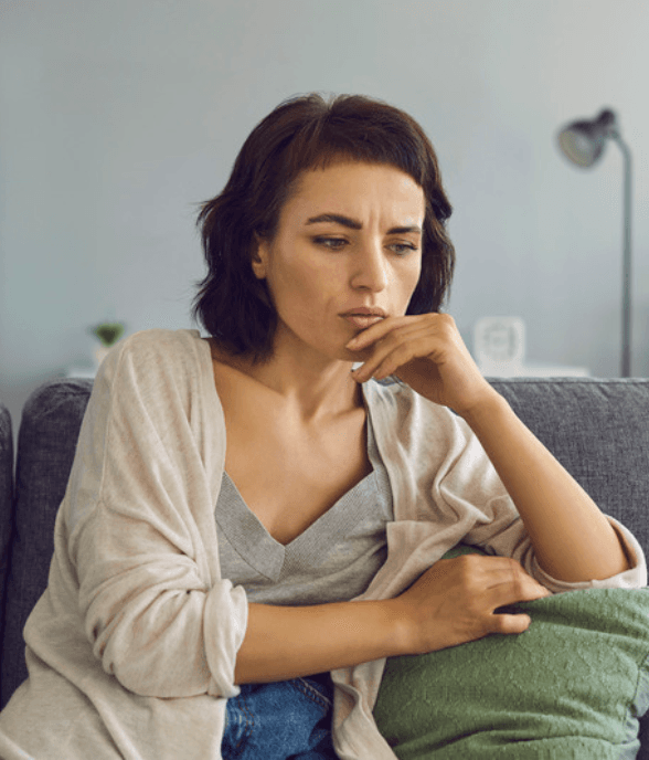 A stepmom sitting quietly, deep in thought