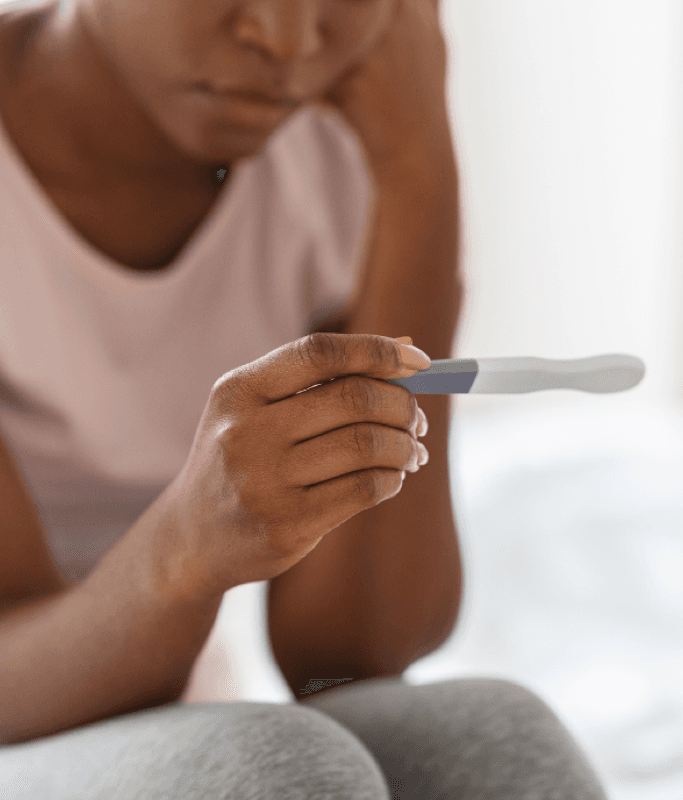 A woman sitting with a quiet, heavy moment