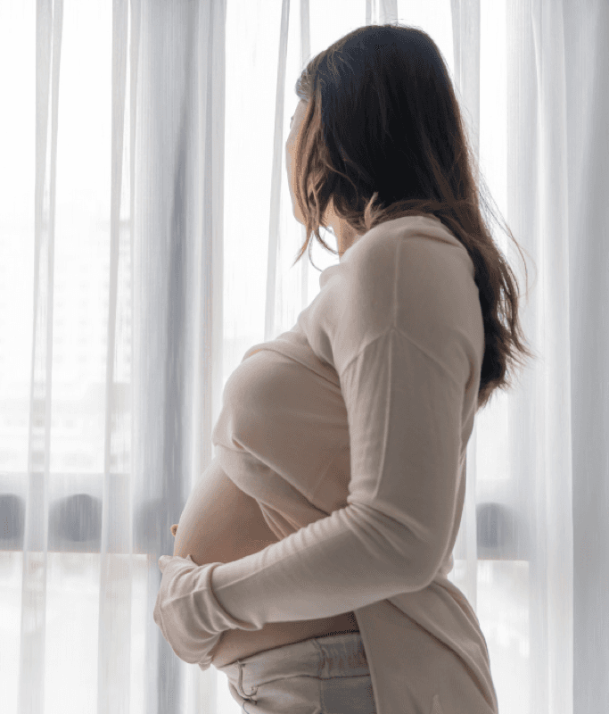 A pregnant mom sitting with her feelings