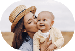 A mom smiling with her baby