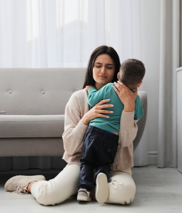 A mom holding her son close in a tender embrace