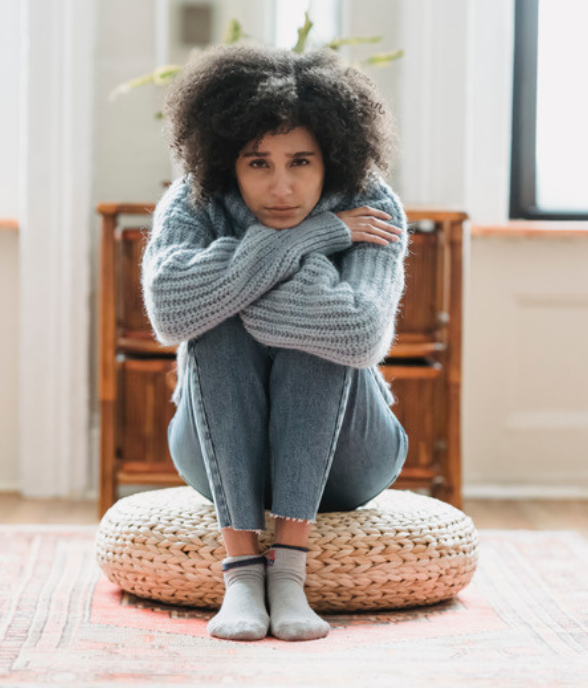 A mom sitting alone, withdrawn and weary