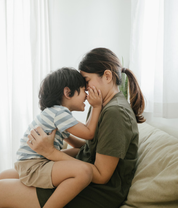 A parent holding their child close in a quiet, connected moment