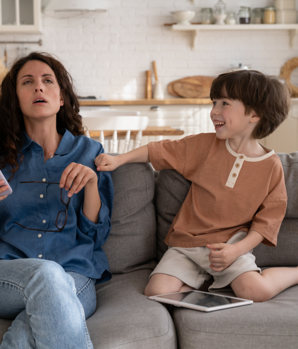 A mom sitting with her child, feeling overwhelmed